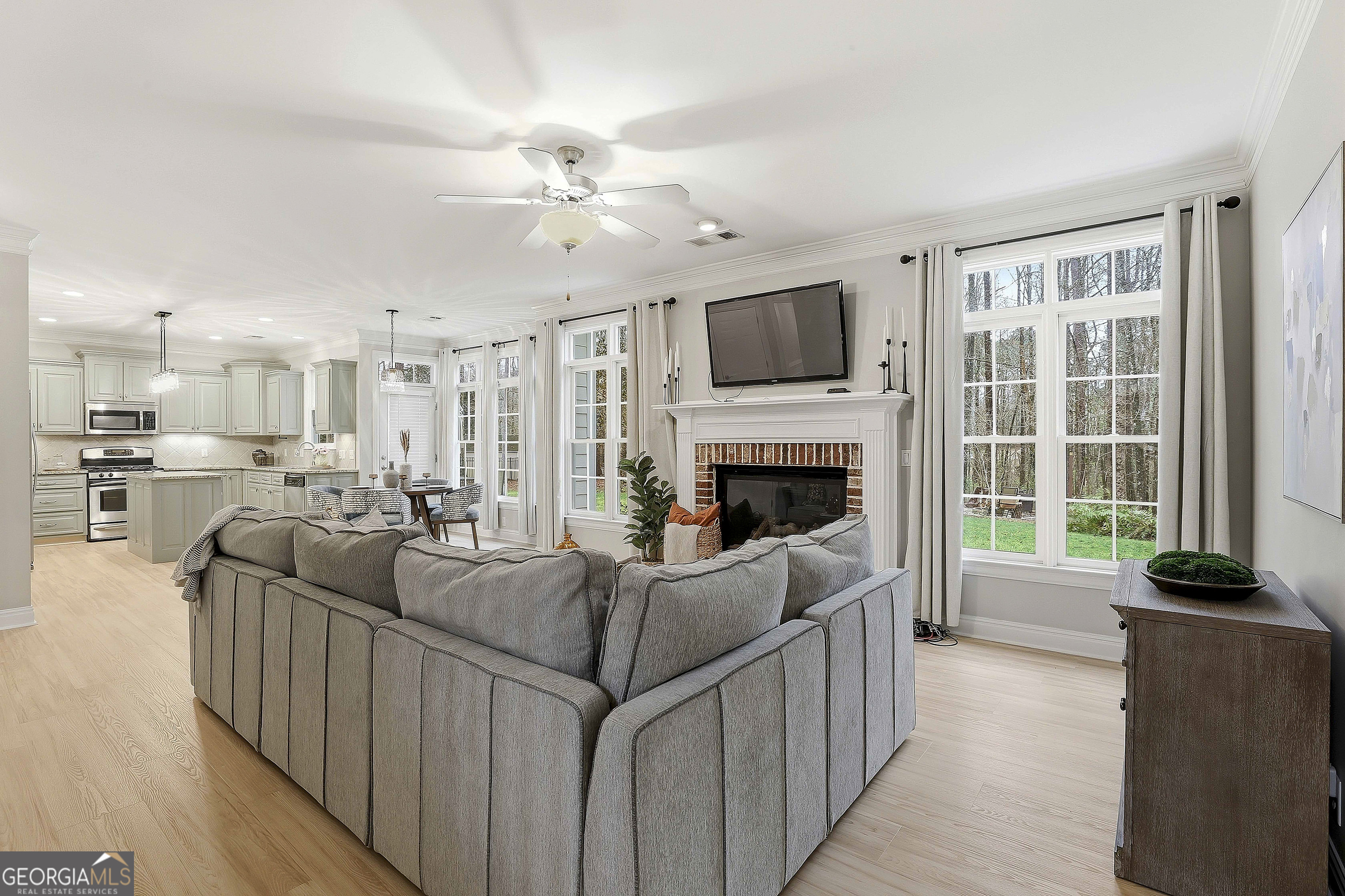 108 Tullamore Trail Tyrone, GA 30290 - Photo 19 of 54 a living room with furniture a flat screen tv and a fireplace