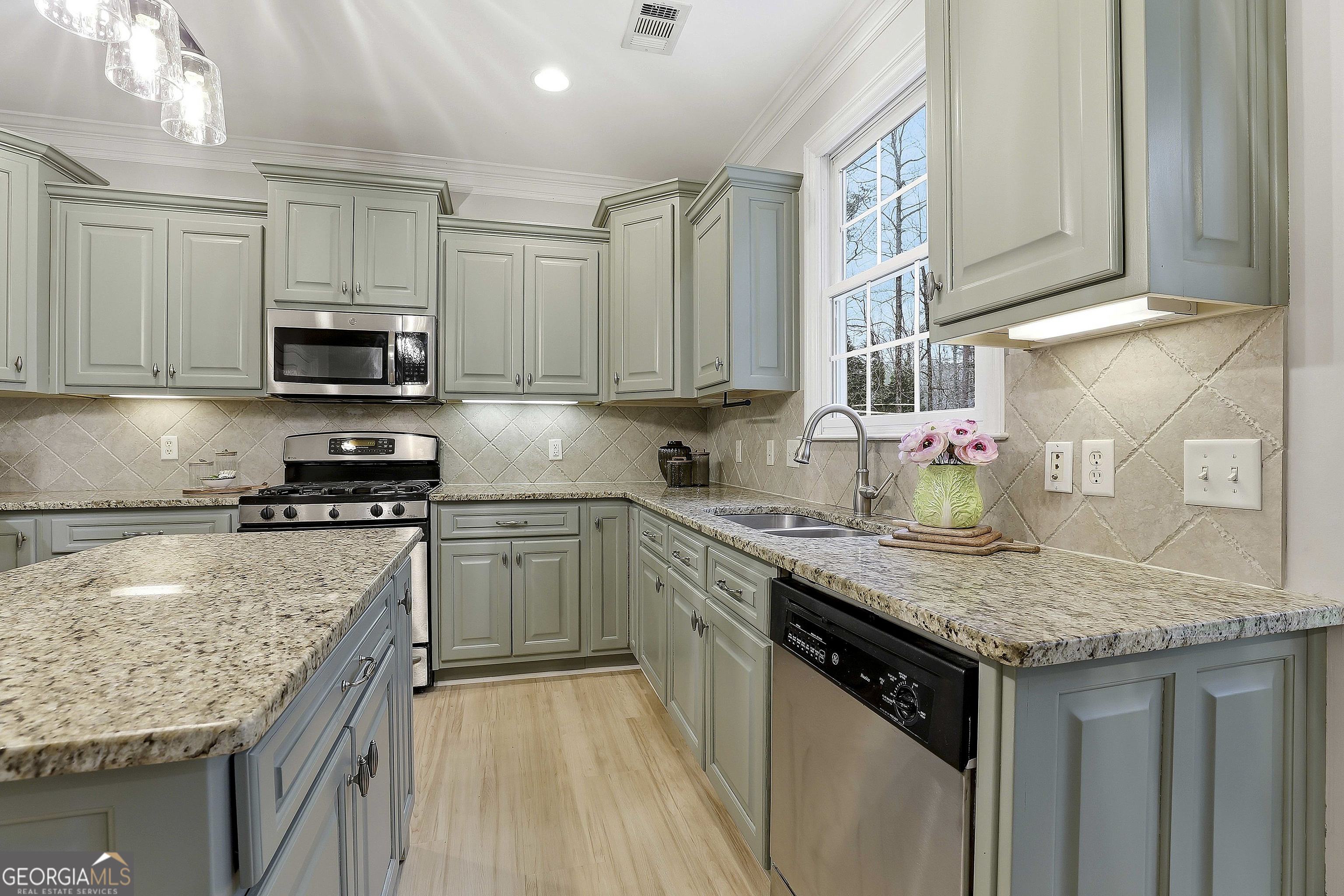 108 Tullamore Trail Tyrone, GA 30290 - Photo 28 of 54 a kitchen with stainless steel appliances granite countertop a sink stove and refrigerator