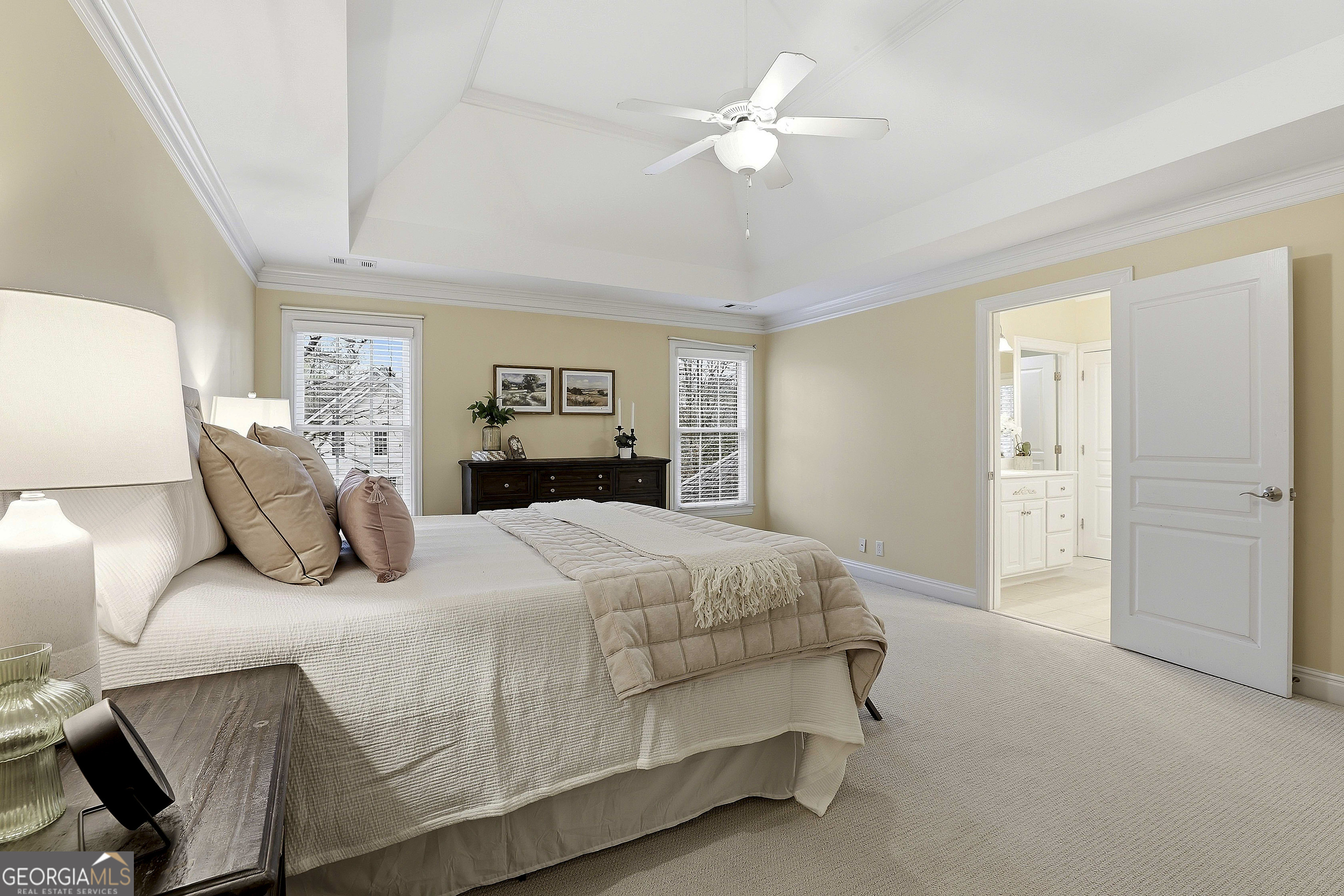 108 Tullamore Trail Tyrone, GA 30290 - Photo 35 of 54 a bedroom with a large bed and a chandelier