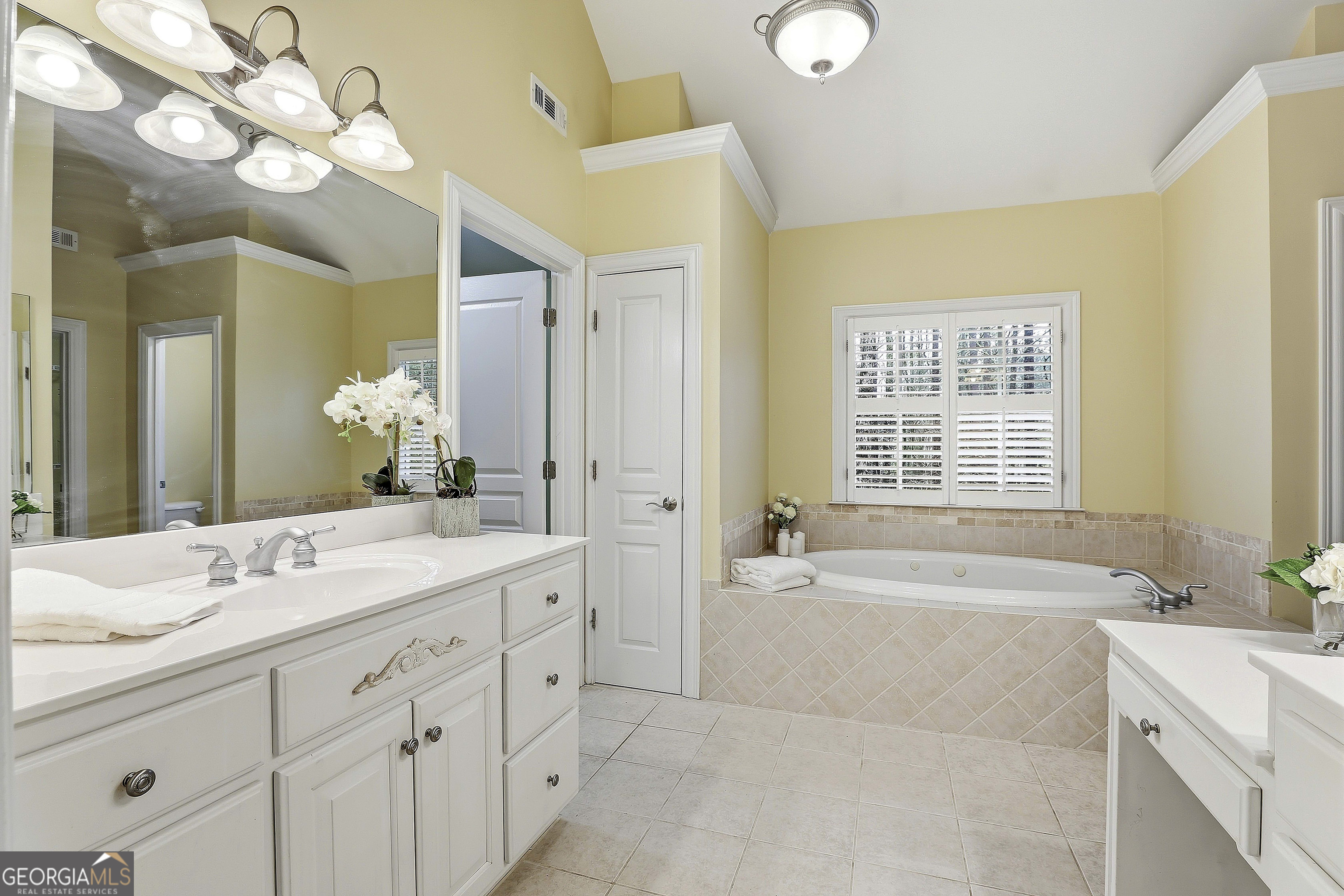 108 Tullamore Trail Tyrone, GA 30290 - Photo 36 of 54 a spacious bathroom with a double vanity sink mirror and a bathtub