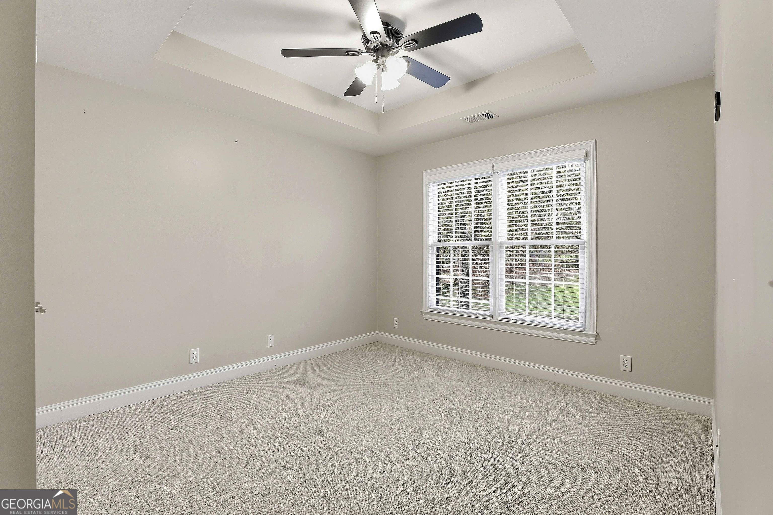 108 Tullamore Trail Tyrone, GA 30290 - Photo 44 of 54 an empty room with a window and a ceiling fan