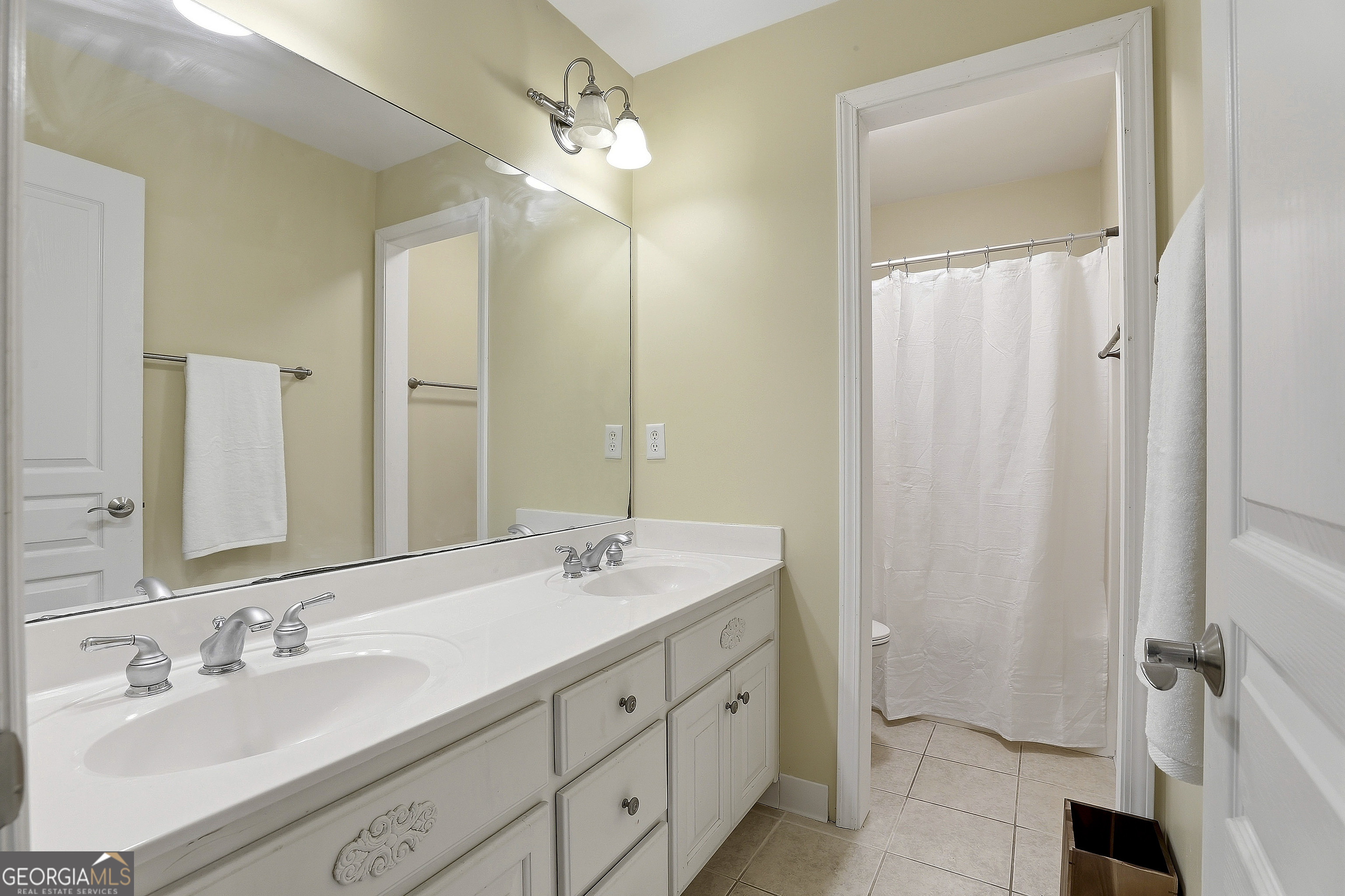 108 Tullamore Trail Tyrone, GA 30290 - Photo 45 of 54 a bathroom with double vanity sink and a mirror