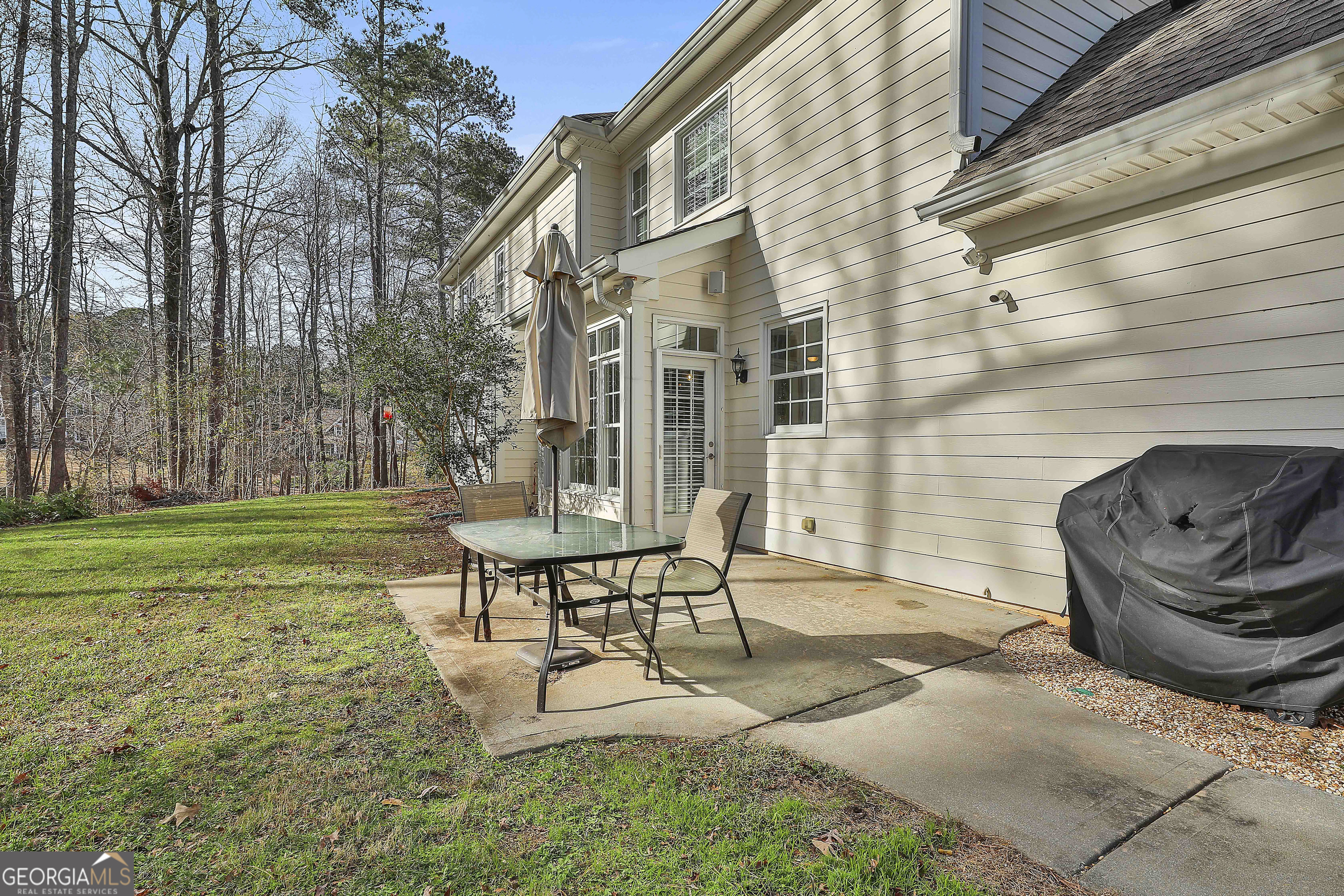 108 Tullamore Trail Tyrone, GA 30290 - Photo 49 of 54 a view of a patio with table and chairs with wooden fence and plants
