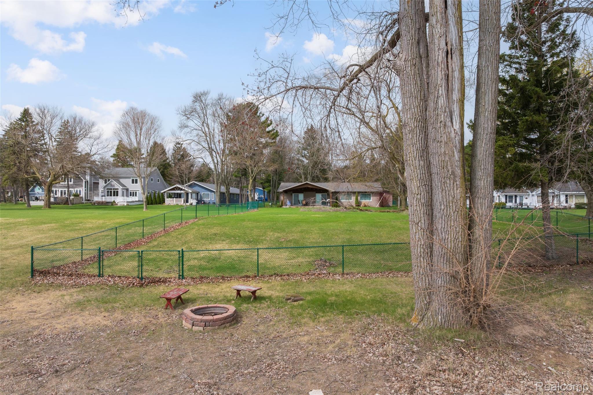 8171 Lakeshore Road Lexington, MI 48450 - Photo 40 of 45 View of yard featuring a residential view and an outdoor fire pit