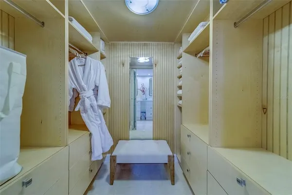 a bedroom with a bed and a large mirror