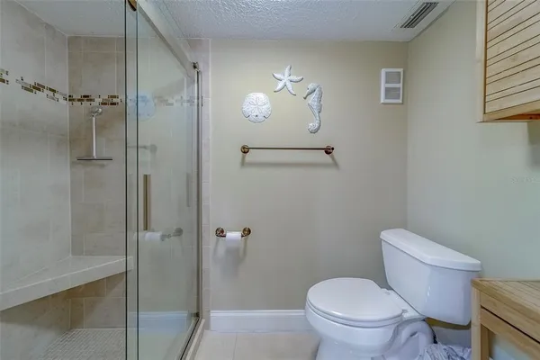 a bathroom with a granite countertop shower a sink and a mirror