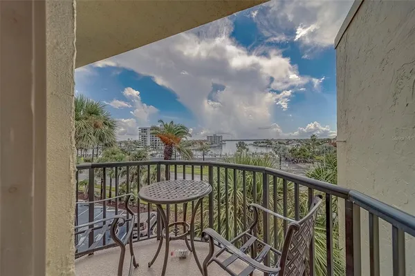 a view of a chairs and table in the balcony