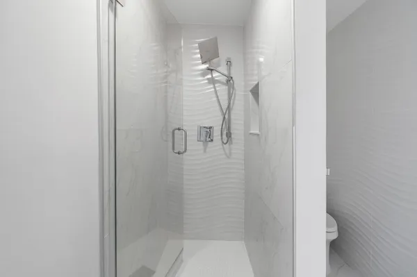 a bathroom with a granite countertop toilet and a sink
