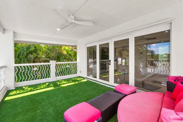 a view of balcony with couches and wooden floor