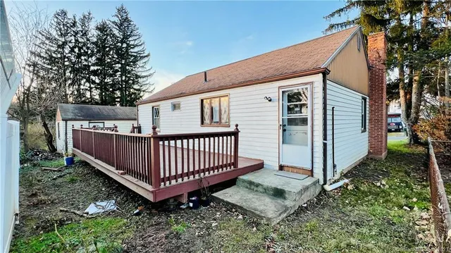 a view of a house with a yard and deck
