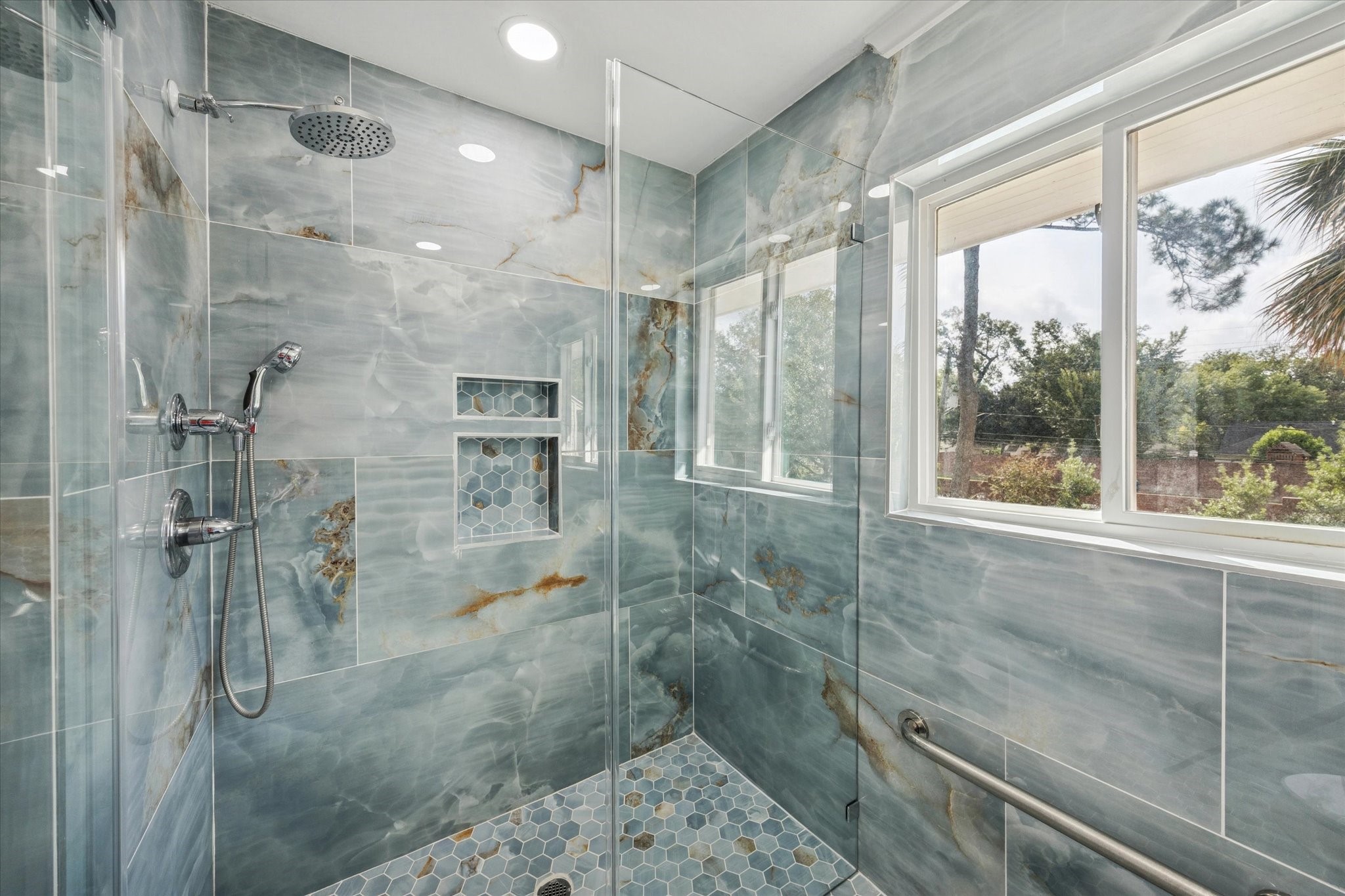 13403 Taylorcrest Road Houston, TX 77079 - Photo 17 of 38 a bathroom with a glass shower door