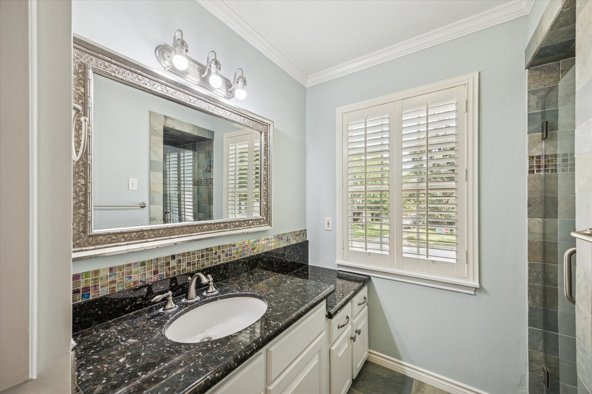13403 Taylorcrest Road Houston, TX 77079 - Photo 20 of 38 a bathroom with a granite countertop sinks a mirror and a window