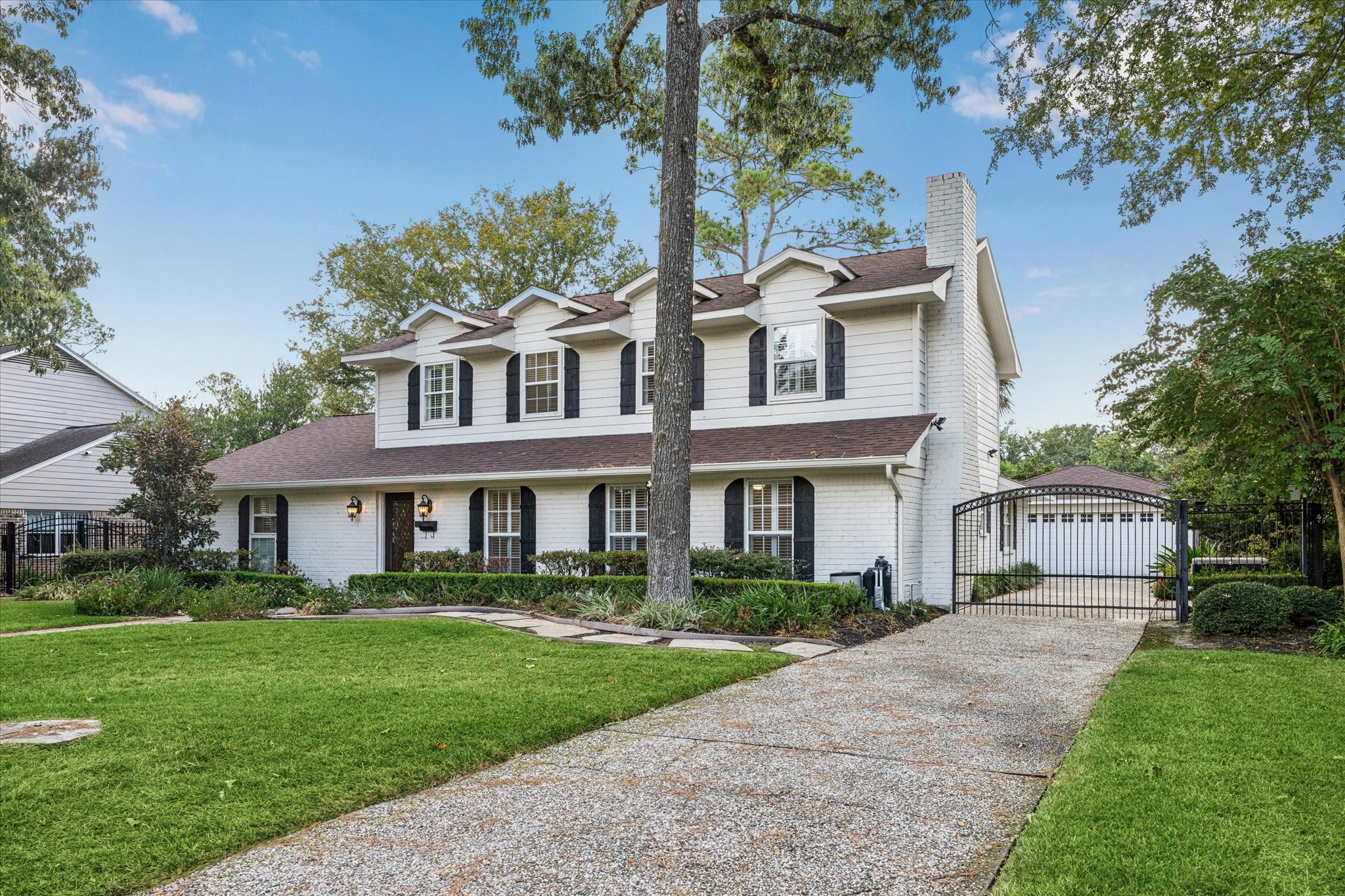 13403 Taylorcrest Road Houston, TX 77079 - Photo 38 of 38 a front view of a house with a yard and potted plants