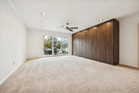 an empty room with windows and closet