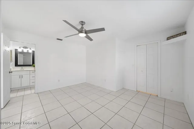 a view of a livingroom with an empty space and a ceiling fan