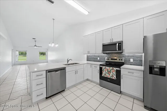 a kitchen with a sink cabinets and stainless steel appliances