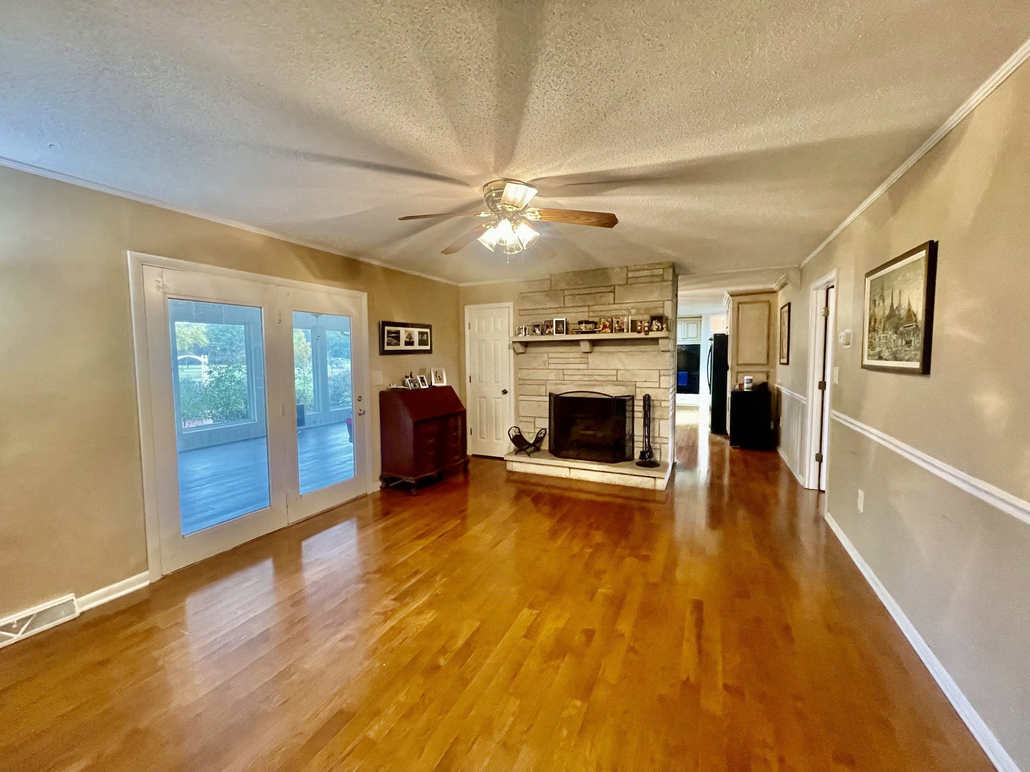 858 Ethridge Red Hill Road Lawrenceburg, TN 38464 - Photo 14 of 46 a view of a livingroom with a fireplace a ceiling fan a fireplace and windows