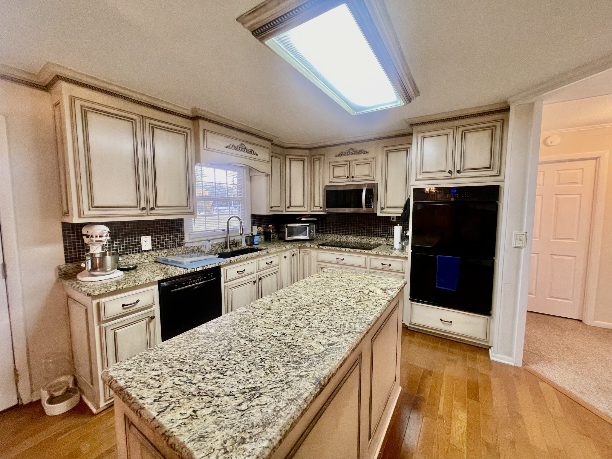 858 Ethridge Red Hill Road Lawrenceburg, TN 38464 - Photo 22 of 46 a kitchen with stainless steel appliances granite countertop a stove top oven a sink dishwasher and a refrigerator