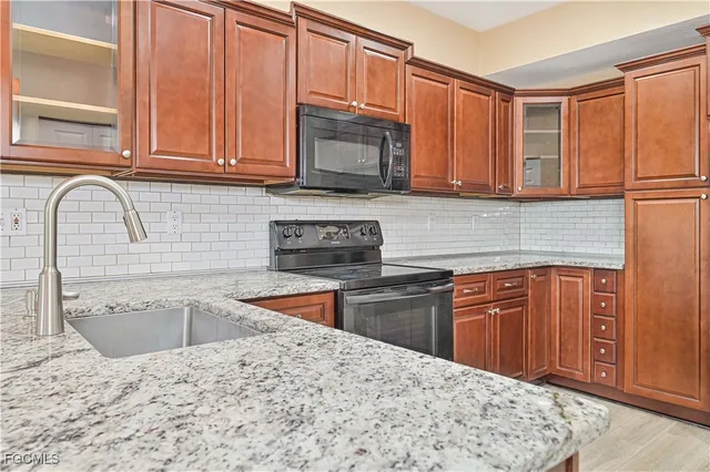 a kitchen with stainless steel appliances granite countertop a refrigerator sink and cabinets