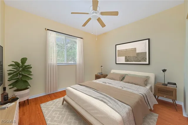 a bedroom with a bed and a potted plant