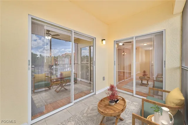 a living room filled with furniture and a glass door