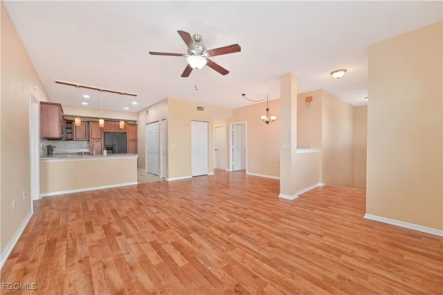 a view of a kitchen with wooden floor and a ceiling fan