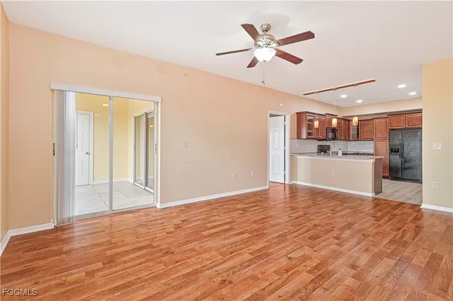 a view of a kitchen with a sink and a refrigerator