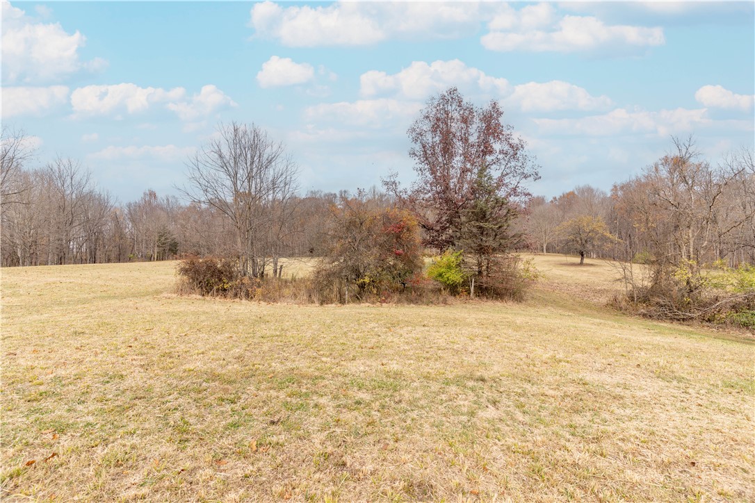 18333 Lefevre Number 2 Road Sidney, OH 45365 - Photo 21 of 25 Expansive natural landscape featuring rolling hills and abundant trees under an open sky.