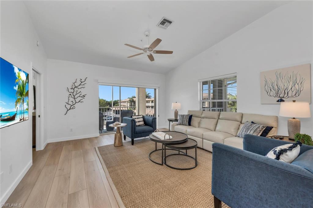 6010 Chardonnay Lane, Unit 304 Naples, FL 34119 - Photo 1 of 29 a living room with furniture a ceiling fan and a rug