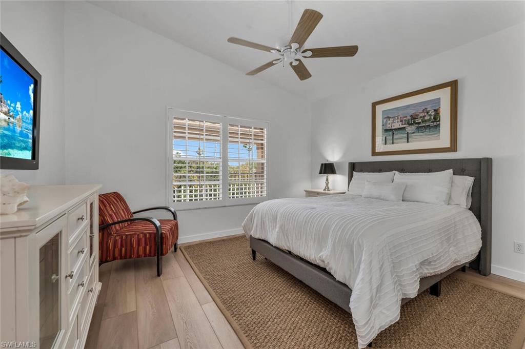 6010 Chardonnay Lane, Unit 304 Naples, FL 34119 - Photo 12 of 29 a bedroom with a bed couch and a window