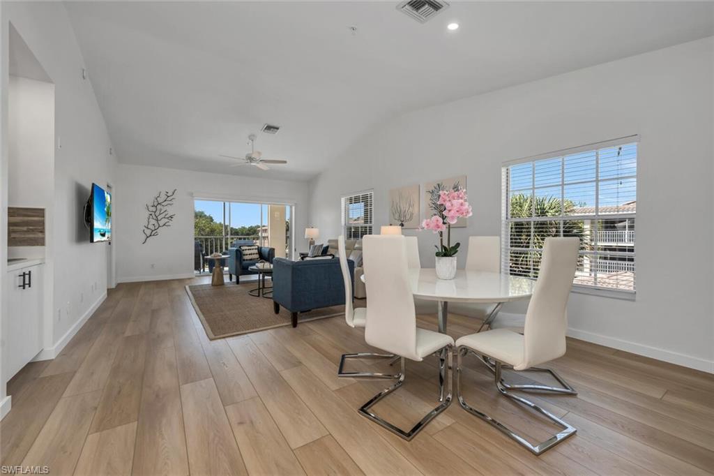 6010 Chardonnay Lane, Unit 304 Naples, FL 34119 - Photo 5 of 29 a view of a dining room with furniture window and wooden floor
