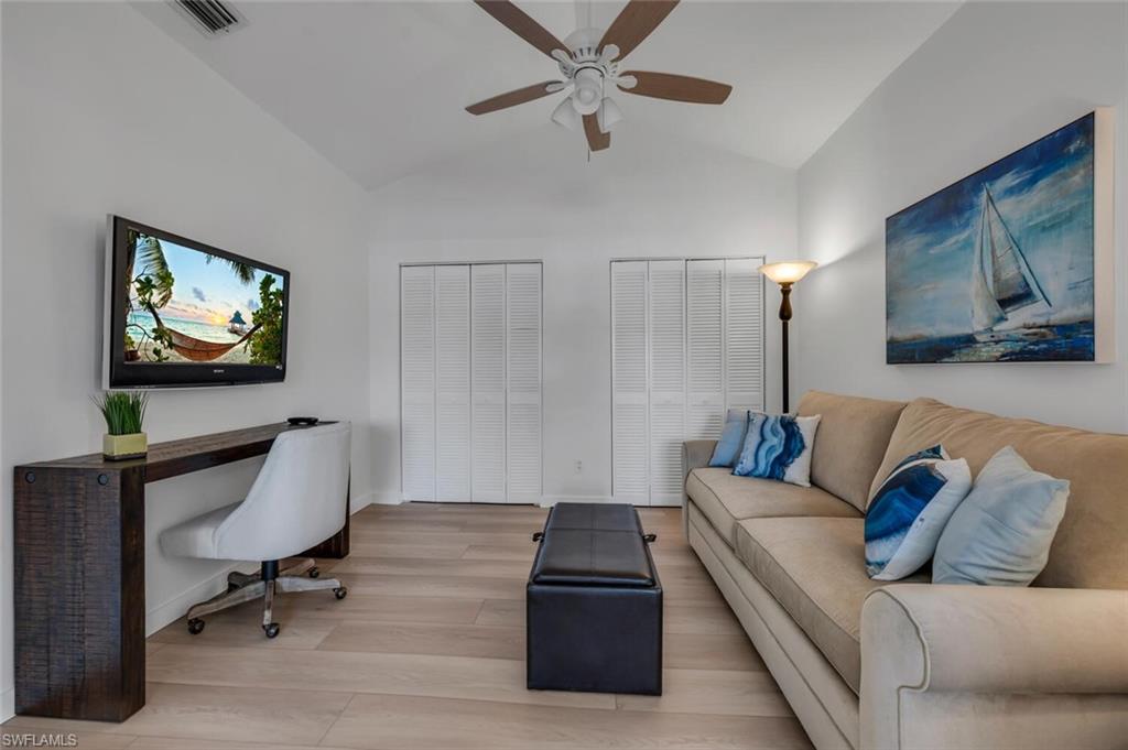 6010 Chardonnay Lane, Unit 304 Naples, FL 34119 - Photo 8 of 29 a living room with furniture and a flat screen tv