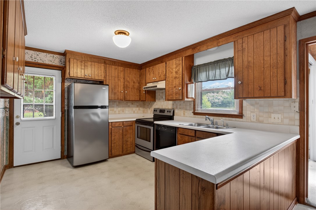 112 Holliday Lane Pendleton, SC 29670 - Photo 5 of 42 Warm wood cabinetry and durable countertops define this functional kitchen space.