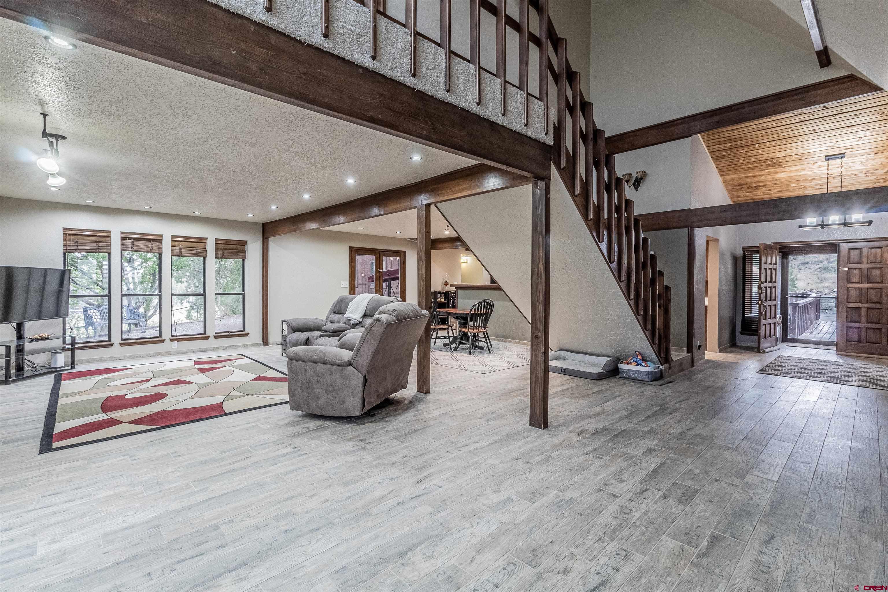 27 Road 3025 Aztec, NM 87410 - Photo 12 of 45 a dining hall with couches and floor to ceiling window