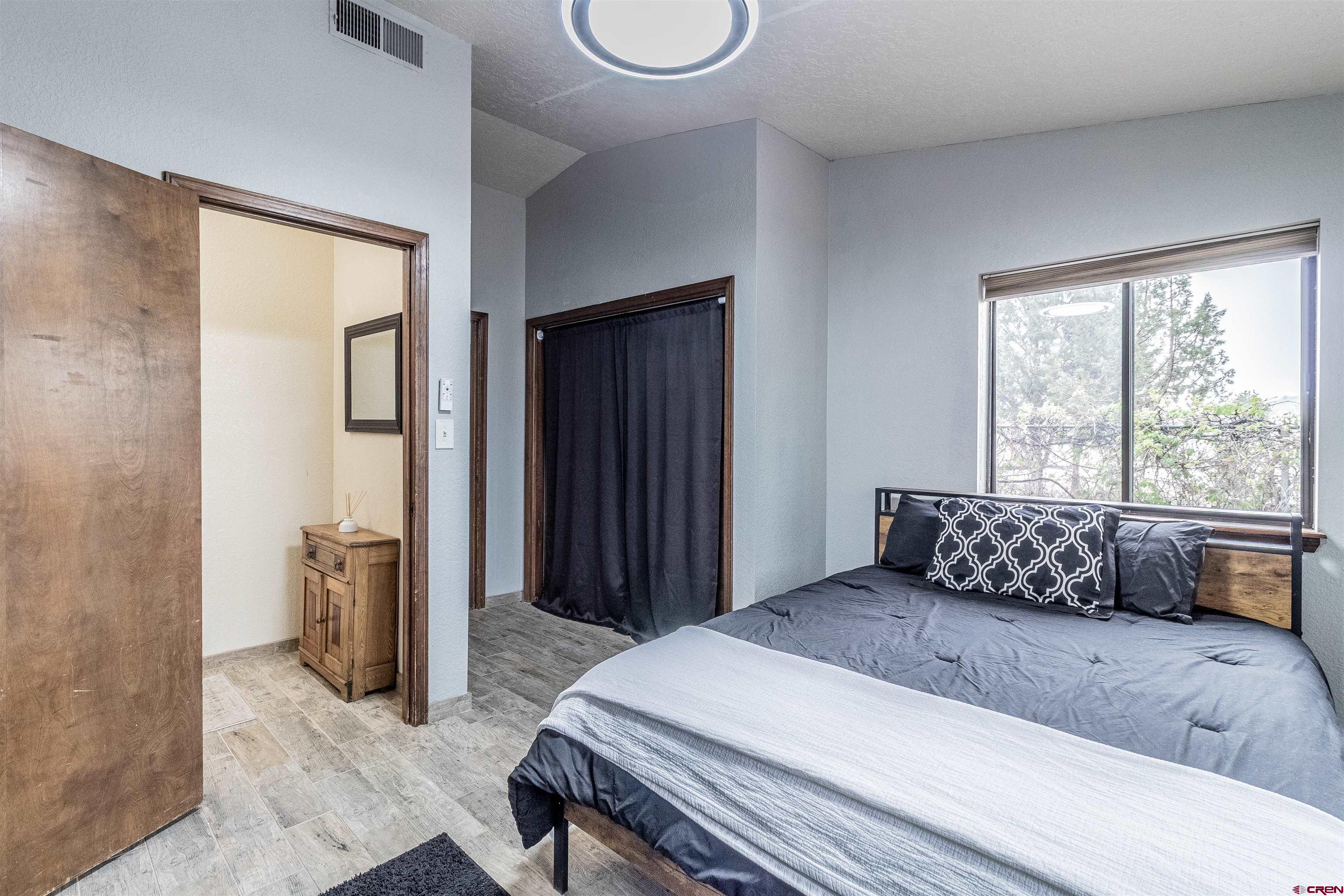 27 Road 3025 Aztec, NM 87410 - Photo 20 of 45 a bedroom with a large bed and a window