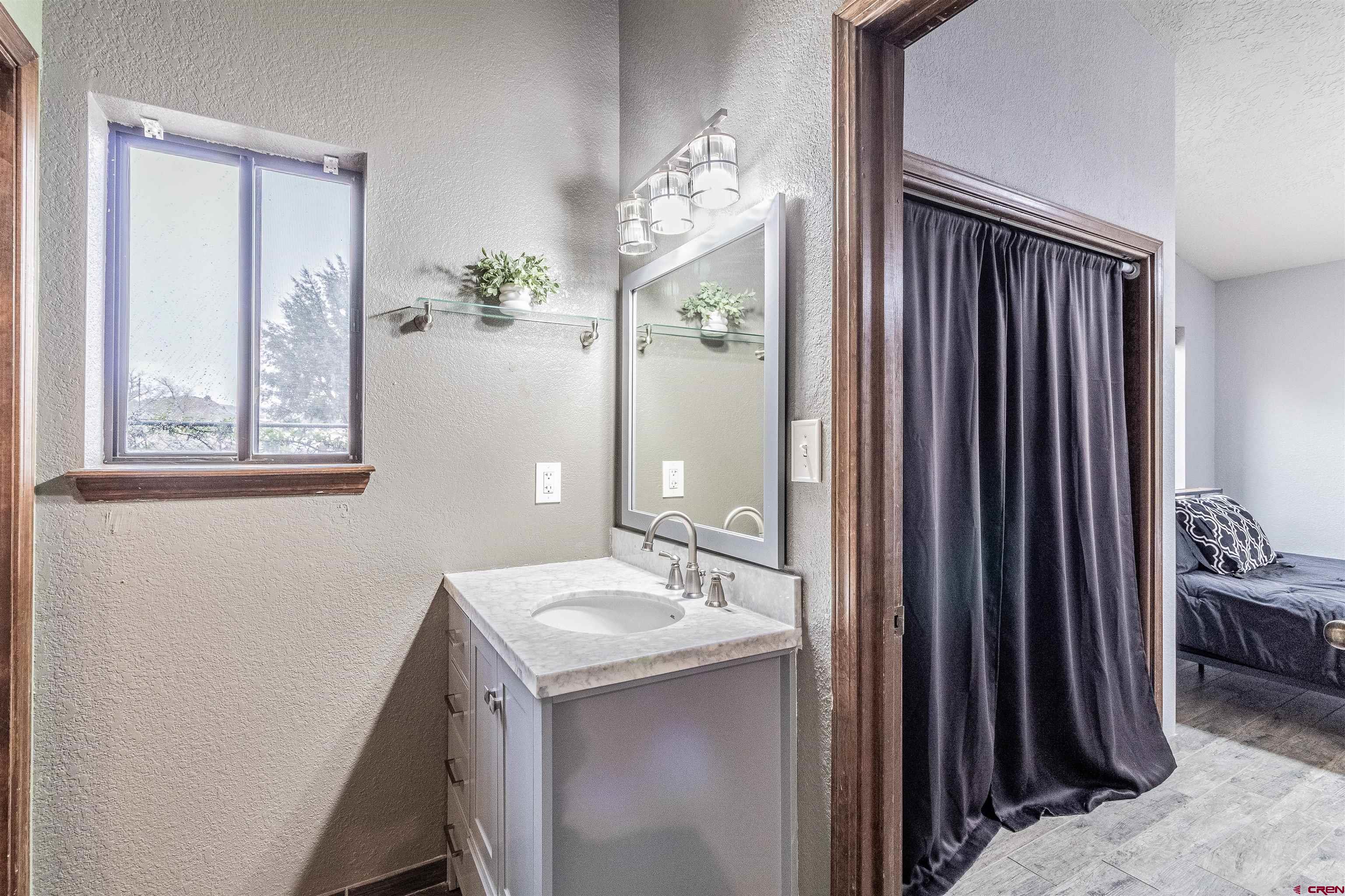 27 Road 3025 Aztec, NM 87410 - Photo 22 of 45 a bathroom with a sink a mirror and a shower