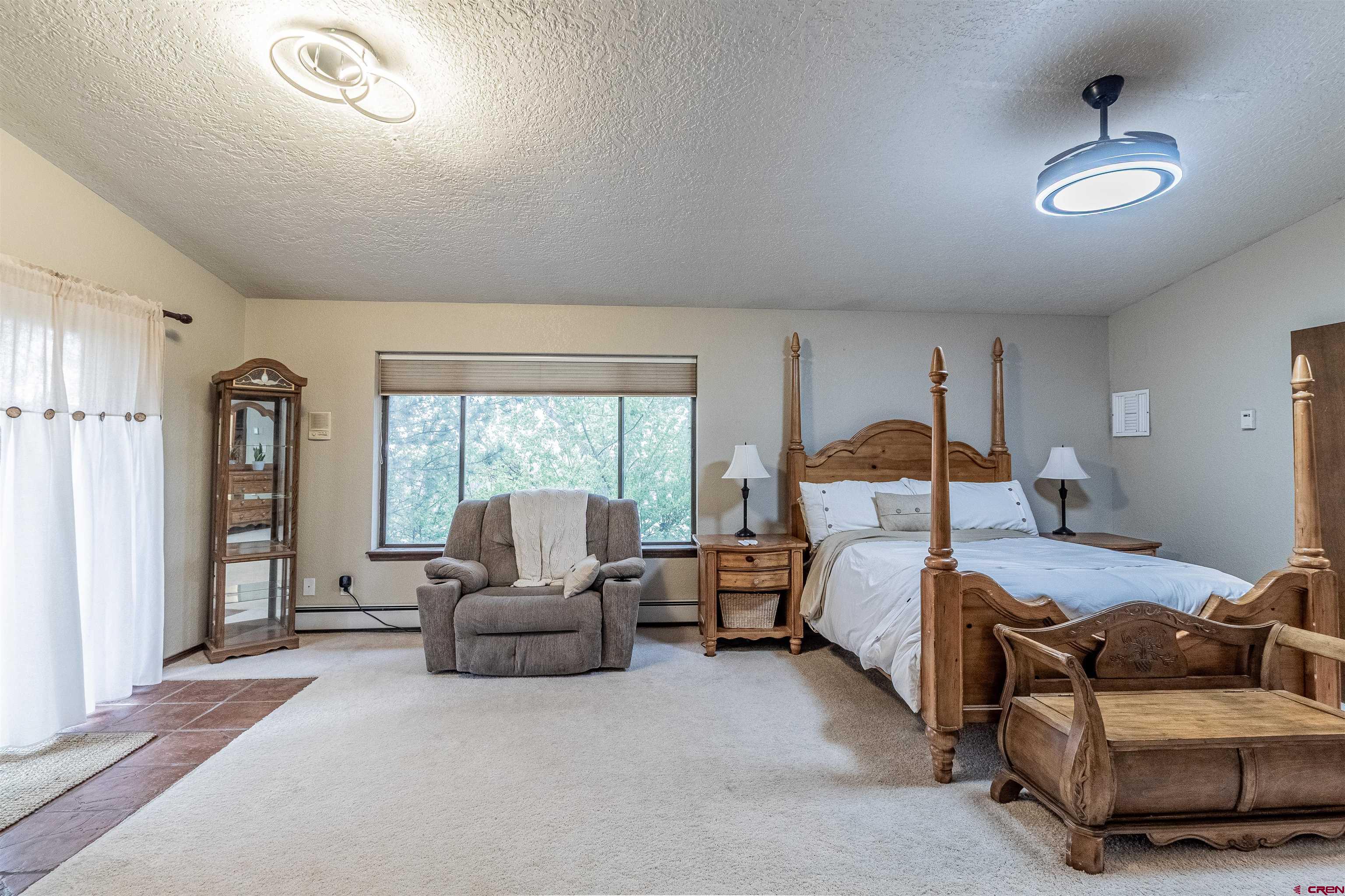 27 Road 3025 Aztec, NM 87410 - Photo 27 of 45 a bedroom with bed couch and window