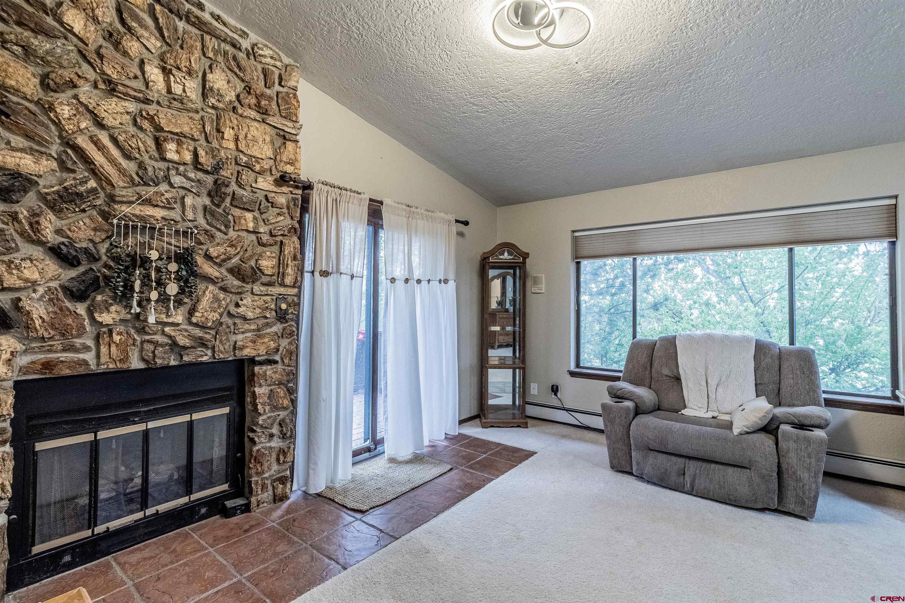 27 Road 3025 Aztec, NM 87410 - Photo 28 of 45 a living room with furniture and a fireplace