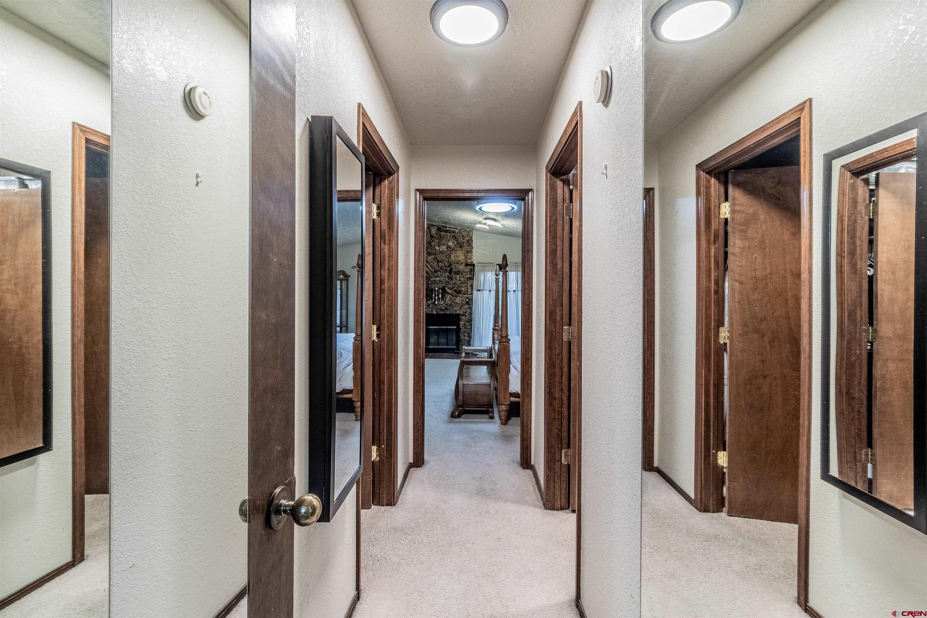 27 Road 3025 Aztec, NM 87410 - Photo 30 of 45 a view of a hallway with closet and a bathroom