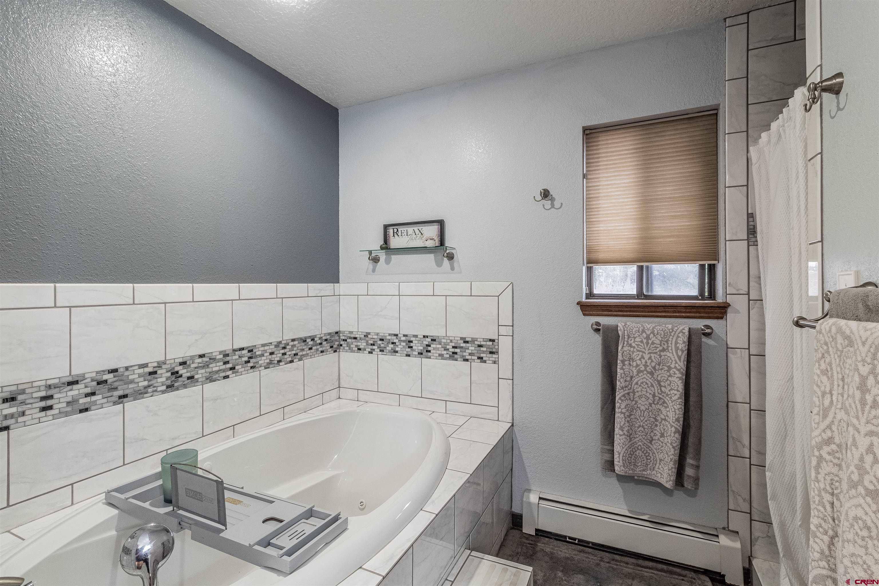 27 Road 3025 Aztec, NM 87410 - Photo 34 of 45 a bathroom with a bathtub and shower