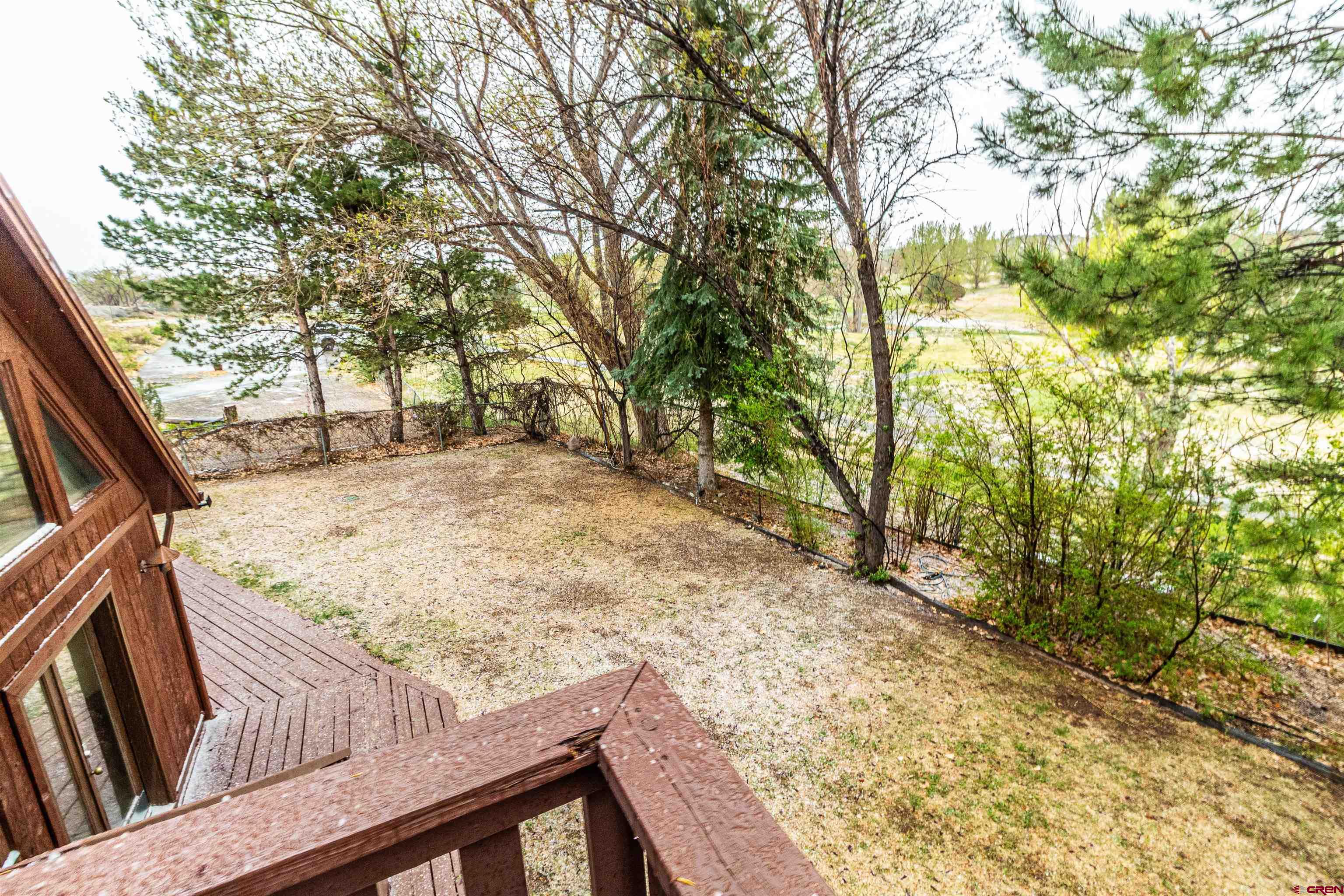 27 Road 3025 Aztec, NM 87410 - Photo 35 of 45 a view of a backyard with wooden fence and large trees