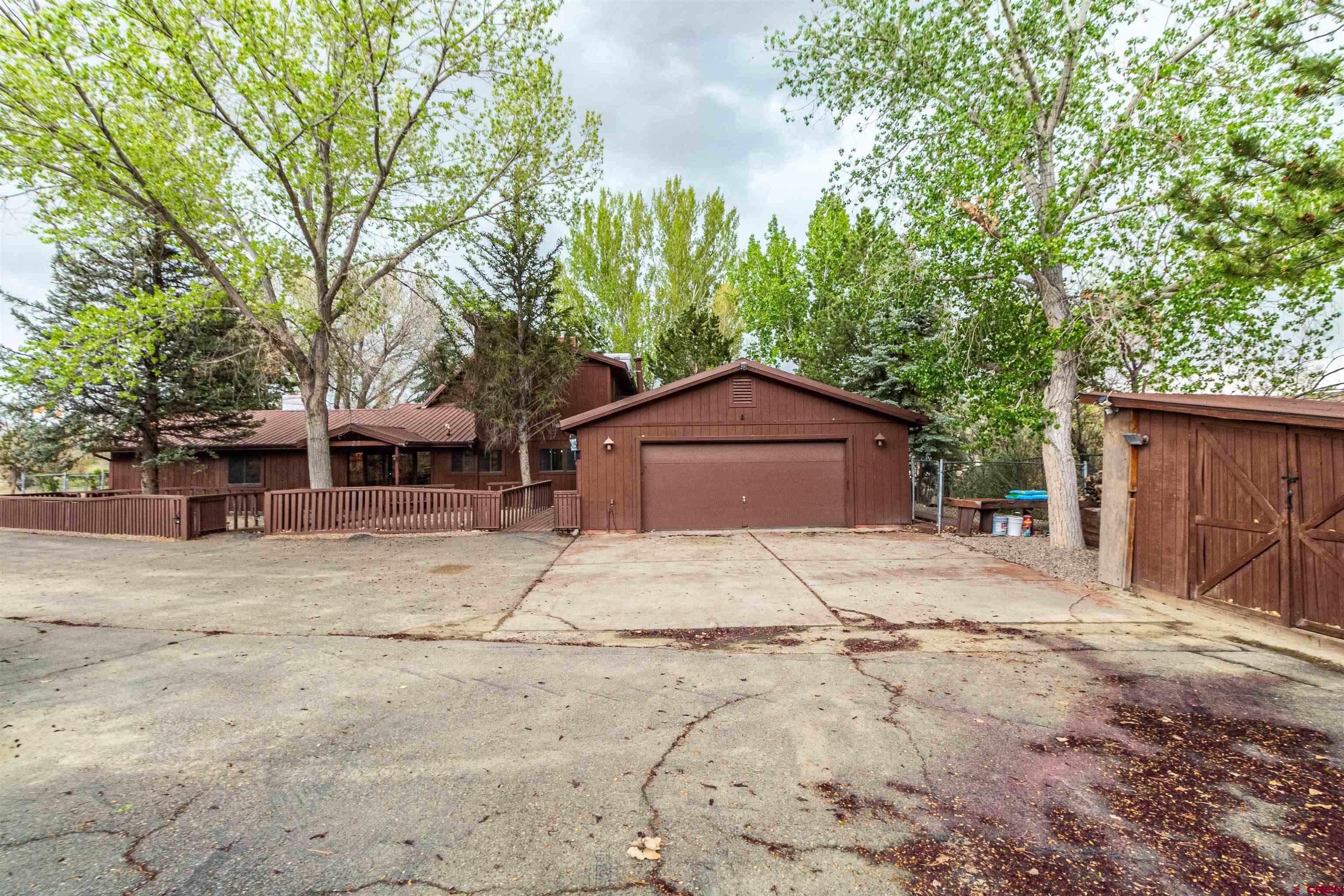27 Road 3025 Aztec, NM 87410 - Photo 38 of 45 a house with trees in the background