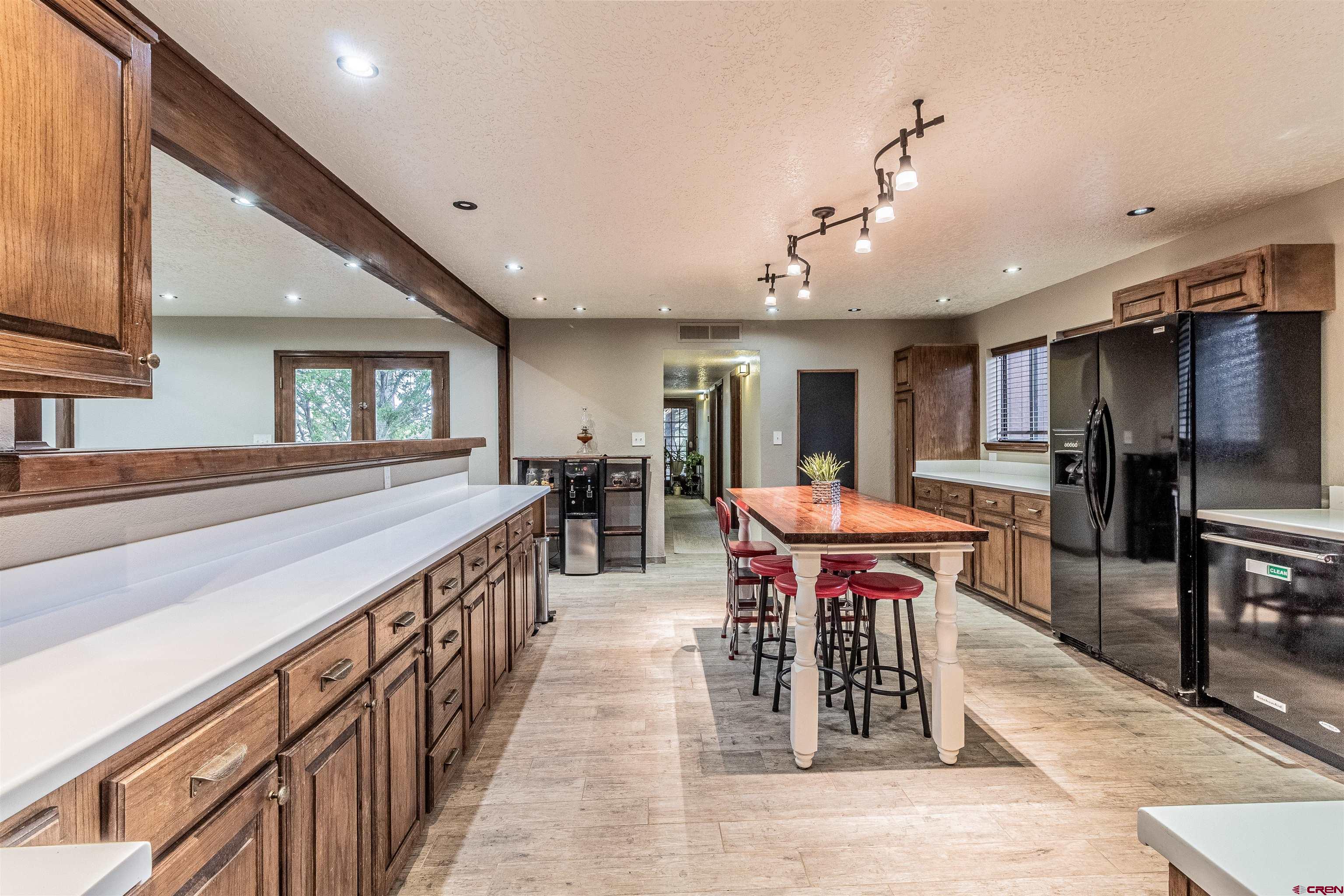 27 Road 3025 Aztec, NM 87410 - Photo 7 of 45 a large kitchen with a table and chairs
