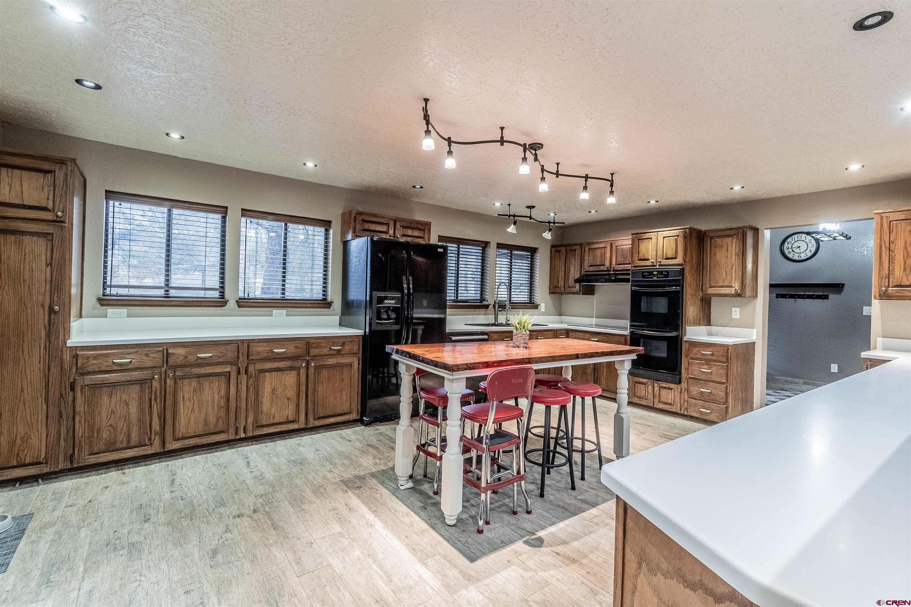 27 Road 3025 Aztec, NM 87410 - Photo 8 of 45 a kitchen with stainless steel appliances kitchen island granite countertop a table chairs sink and cabinets