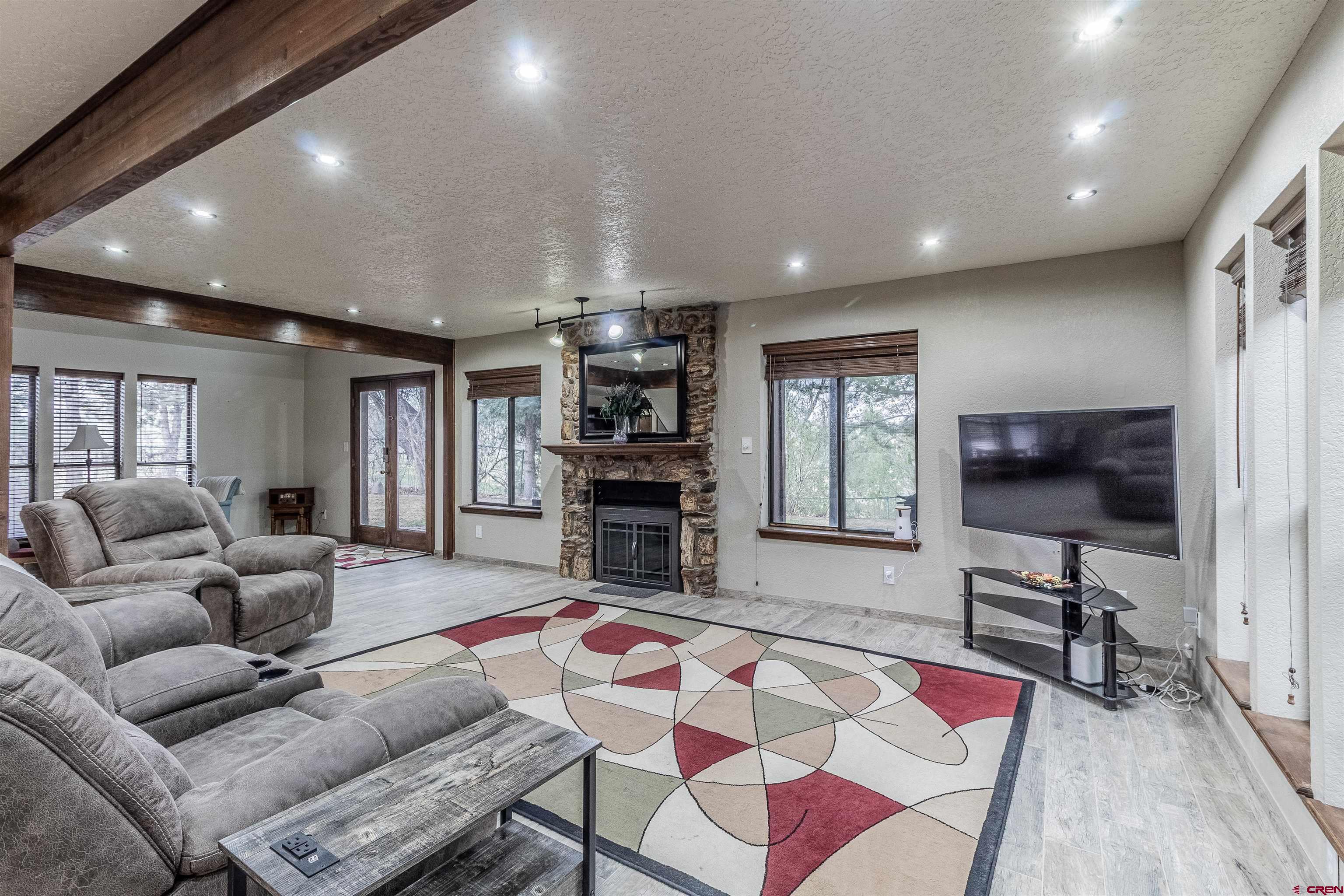 27 Road 3025 Aztec, NM 87410 - Photo 10 of 45 a living room with furniture a flat screen tv and kitchen view