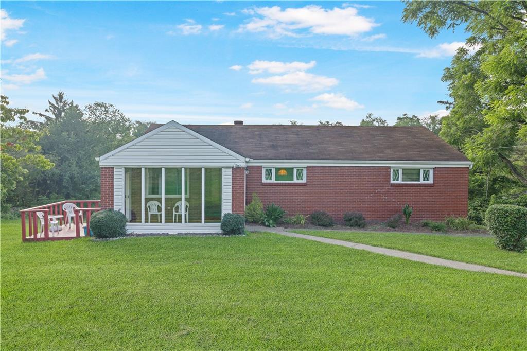 a front view of a house with a garden