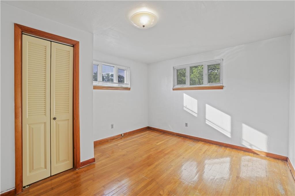 1027 Glass Run Road Pittsburgh, PA 15236 - Photo 14 of 24 an empty room with wooden floor and windows