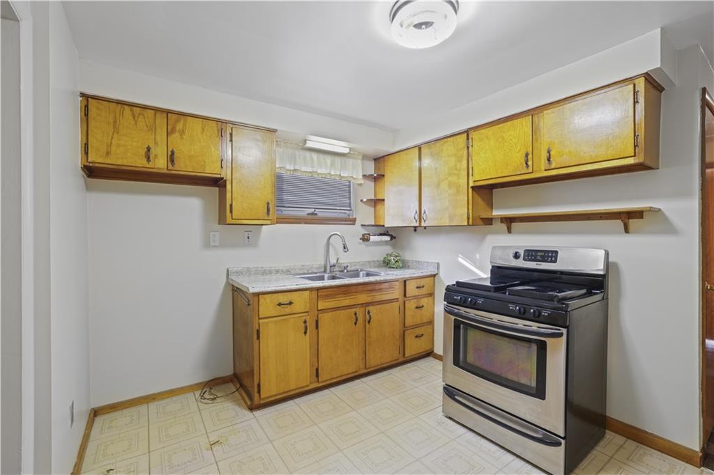 1027 Glass Run Road Pittsburgh, PA 15236 - Photo 10 of 24 a kitchen with stainless steel appliances granite countertop a stove sink and cabinets