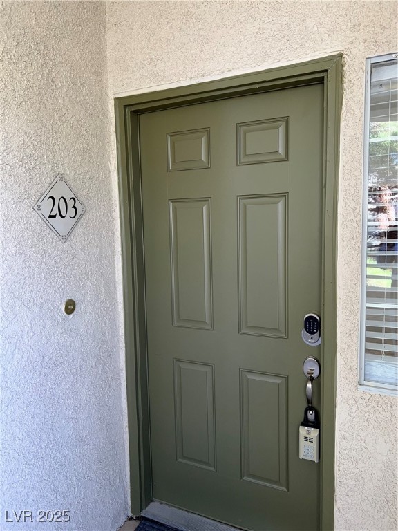 1705 King James Street, Unit 203 Las Vegas, NV 89144 - Photo 2 of 21 Property entrance featuring stucco siding