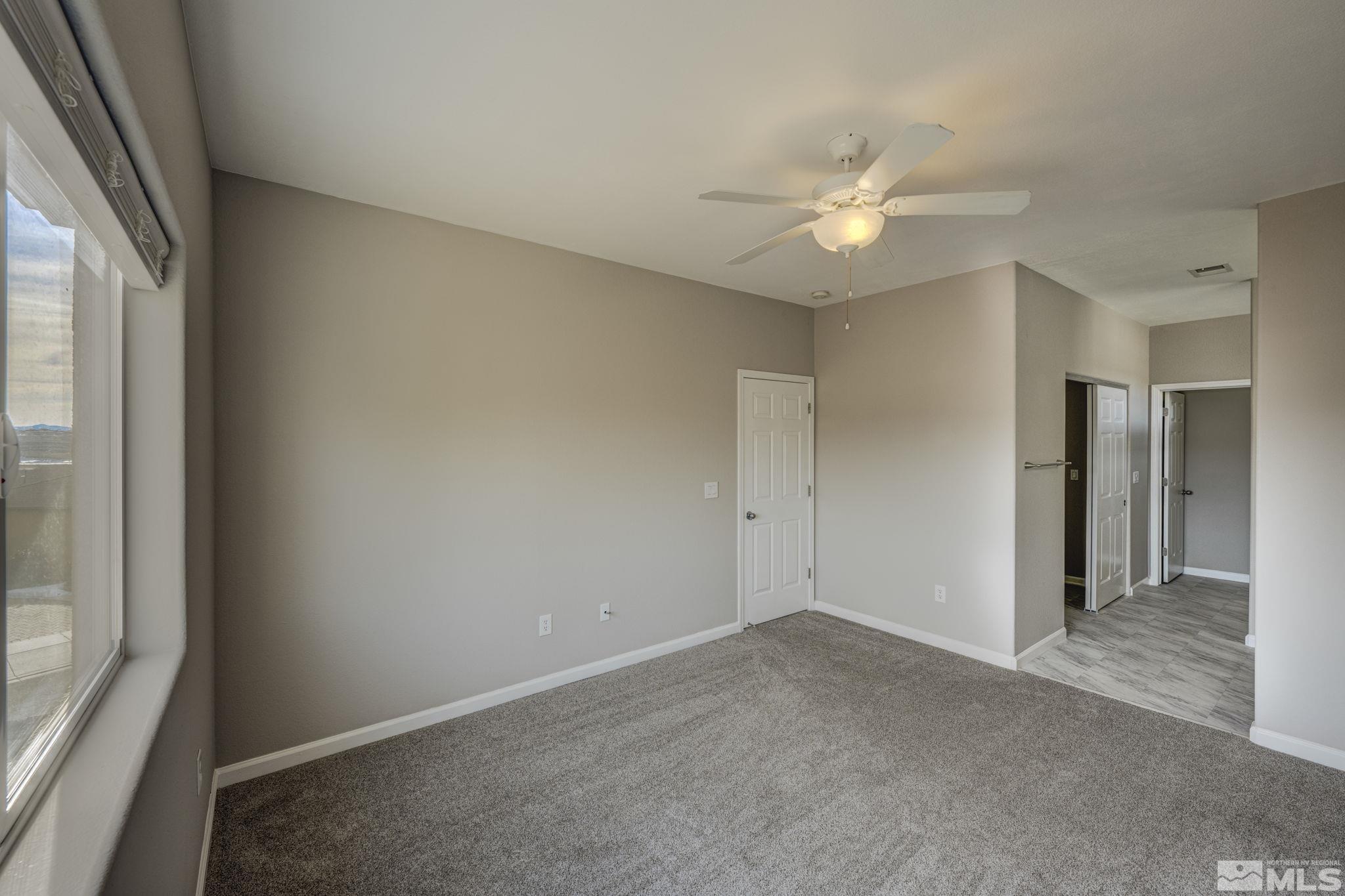 5155 Emery Drive Reno, NV 89506 - Photo 11 of 38 an empty room with closet and a chandelier fan